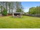 Large backyard featuring an outdoor kitchen and a lush green lawn at 218 Darecrest Ln, Wendell, NC 27591