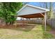 Backyard featuring a large open structure with a light blue roof at 218 Darecrest Ln, Wendell, NC 27591