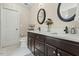 Bright bathroom featuring double vanities, dark wood cabinets, and neutral wall color at 218 Darecrest Ln, Wendell, NC 27591