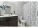 Bathroom featuring dark cabinets, patterned shower curtain, and decorative accents at 218 Darecrest Ln, Wendell, NC 27591