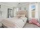 Cozy bedroom featuring tufted headboard, plush bedding, and natural light from windows at 218 Darecrest Ln, Wendell, NC 27591