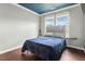 Cozy bedroom with a blue accent ceiling, large window, and a comfortable bed at 218 Darecrest Ln, Wendell, NC 27591