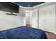 Bedroom with blue color scheme, dark blue accent ceiling, and modern ceiling fan at 218 Darecrest Ln, Wendell, NC 27591