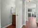 Well-lit hallway featuring a wooden vanity and access to multiple rooms at 218 Darecrest Ln, Wendell, NC 27591