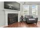 Stylish living room featuring a fireplace, comfortable armchair, and hardwood floors at 218 Darecrest Ln, Wendell, NC 27591
