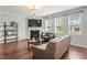 Cozy living room with fireplace, hardwood floors, and natural light at 218 Darecrest Ln, Wendell, NC 27591