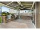 Outdoor kitchen and bar area with built-in BBQ grill, stainless-steel mini fridge and stained wood ceiling at 218 Darecrest Ln, Wendell, NC 27591