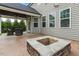 Back patio view of an outdoor fire pit area with backyard view of landscaping and covered seating area at 218 Darecrest Ln, Wendell, NC 27591