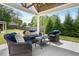 Outdoor patio with comfortable seating, a stylish coffee table and beautiful wood ceiling details at 218 Darecrest Ln, Wendell, NC 27591