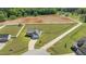 Aerial view of the home, surrounded by a large yard and distant farmland at 241 Connelly Way, Zebulon, NC 27597