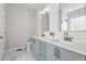Spacious bathroom boasts double sinks, modern fixtures, blue vanity, and excellent natural lighting at 241 Connelly Way, Zebulon, NC 27597