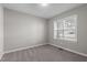 Bedroom features natural lighting and soft carpet at 241 Connelly Way, Zebulon, NC 27597