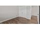 Well-lit bedroom featuring hardwood floors, neutral walls, and a double-door closet at 241 Connelly Way, Zebulon, NC 27597