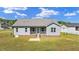 Home exterior features a covered porch, gray siding, and landscaped yard at 241 Connelly Way, Zebulon, NC 27597