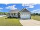 Charming single-Gathering home with a well-manicured lawn and a two-car garage at 241 Connelly Way, Zebulon, NC 27597