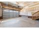 Spacious two-car garage with unfinished drywall, concrete floor, and an opener at 241 Connelly Way, Zebulon, NC 27597