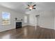 Cozy living room with a fireplace, hardwood floors, and natural light at 241 Connelly Way, Zebulon, NC 27597