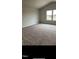 Bright, carpeted bedroom with two windows allowing ample natural light at 249 Landon Pl, Roxboro, NC 27573