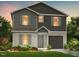 Charming two-story home featuring gray vinyl siding, shutters, landscaped yard, and a one-car garage at 249 Landon Pl, Roxboro, NC 27573