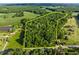 Aerial view of a wooded parcel with a yellow-lined boundary, showcasing its size and natural surroundings at 2509 Nc 57, Hillsborough, NC 27278