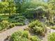 Aerial view of lush backyard with mature trees, winding pathways, and outdoor seating area at 2509 Nc 57, Hillsborough, NC 27278