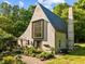 Exterior of home with large multi pane window and lush gardens at 2509 Nc 57, Hillsborough, NC 27278