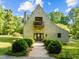 Charming home with unique architecture, front balcony, brick path and mature landscaping, and an inviting entrance at 2509 Nc 57, Hillsborough, NC 27278