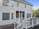 Back exterior showcases a deck with white railings and a screened-in porch, perfect for outdoor enjoyment at 2808 Polesdon Ct, Raleigh, NC 27615