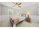 This bedroom features a window, ceiling fan and a bed at 2808 Polesdon Ct, Raleigh, NC 27615