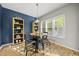 Eat-in kitchen has blue accent wall with views of the outside through a large window at 2808 Polesdon Ct, Raleigh, NC 27615