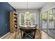 Cozy dining area featuring a round wooden table, stylish chairs, and a sliding door leading to outdoor deck at 2808 Polesdon Ct, Raleigh, NC 27615