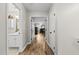 Hallway with hardwood floors connecting the bathroom and bedroom, enhancing the home's flow and accessibility at 2808 Polesdon Ct, Raleigh, NC 27615