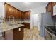 Traditional kitchen featuring wooden cabinets, granite countertops, stainless steel appliances, and tile backsplash at 2808 Polesdon Ct, Raleigh, NC 27615