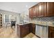 Well-appointed kitchen with granite countertops, stainless steel appliances, and a view into the dining area at 2808 Polesdon Ct, Raleigh, NC 27615