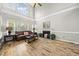 Bright living room with high ceilings, large windows, fireplace, and hardwood floors creating a welcoming space at 2808 Polesdon Ct, Raleigh, NC 27615