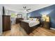 Spacious main bedroom with a dark blue accent wall and wooden furniture with a large bed at 2808 Polesdon Ct, Raleigh, NC 27615
