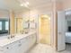 Bright bathroom featuring a double vanity, large mirror, and a walk-in closet at 2813 Market Bridge Ln # 204, Raleigh, NC 27608
