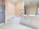 Bathroom featuring a shower, jacuzzi tub with tile surround, and a vanity with a large mirror at 2813 Market Bridge Ln # 204, Raleigh, NC 27608