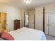 Bedroom with four-poster bed, dresser, ensuite bathroom, and large closet at 2813 Market Bridge Ln # 204, Raleigh, NC 27608
