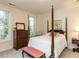 Bedroom with four-poster bed, bench, and window with lots of light at 2813 Market Bridge Ln # 204, Raleigh, NC 27608