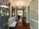 Inviting entryway featuring hardwood floors, floral wallpaper, and a chandelier creating a warm welcome at 2813 Market Bridge Ln # 204, Raleigh, NC 27608