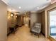 Well-lit hallway with tiled flooring, stylish seating, and neutral-toned walls exudes a welcoming ambiance at 2813 Market Bridge Ln # 204, Raleigh, NC 27608