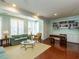Bright living room with large windows, hardwood floors, built-in bookshelves, and a neutral color palette at 2813 Market Bridge Ln # 204, Raleigh, NC 27608