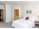 Calm main bedroom with neutral walls, crown molding, carpet and an open doorway to a bathroom suite at 2813 Market Bridge Ln # 204, Raleigh, NC 27608