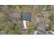 Aerial view of a home nestled among lush trees with a long driveway at 3011 Bourbon St, Sanford, NC 27332