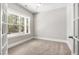 Bedroom features neutral walls, carpeted floors, and French doors at 3011 Bourbon St, Sanford, NC 27332