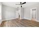 Bright bedroom with hardwood floors and open doorway to bathroom at 3011 Bourbon St, Sanford, NC 27332