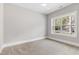 Bedroom with neutral walls, plush carpet, and a bright window at 3011 Bourbon St, Sanford, NC 27332