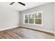 Light-filled bedroom with a ceiling fan, large window, and neutral walls at 3011 Bourbon St, Sanford, NC 27332