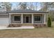 Charming home exterior with a welcoming front porch and well-manicured lawn at 3011 Bourbon St, Sanford, NC 27332